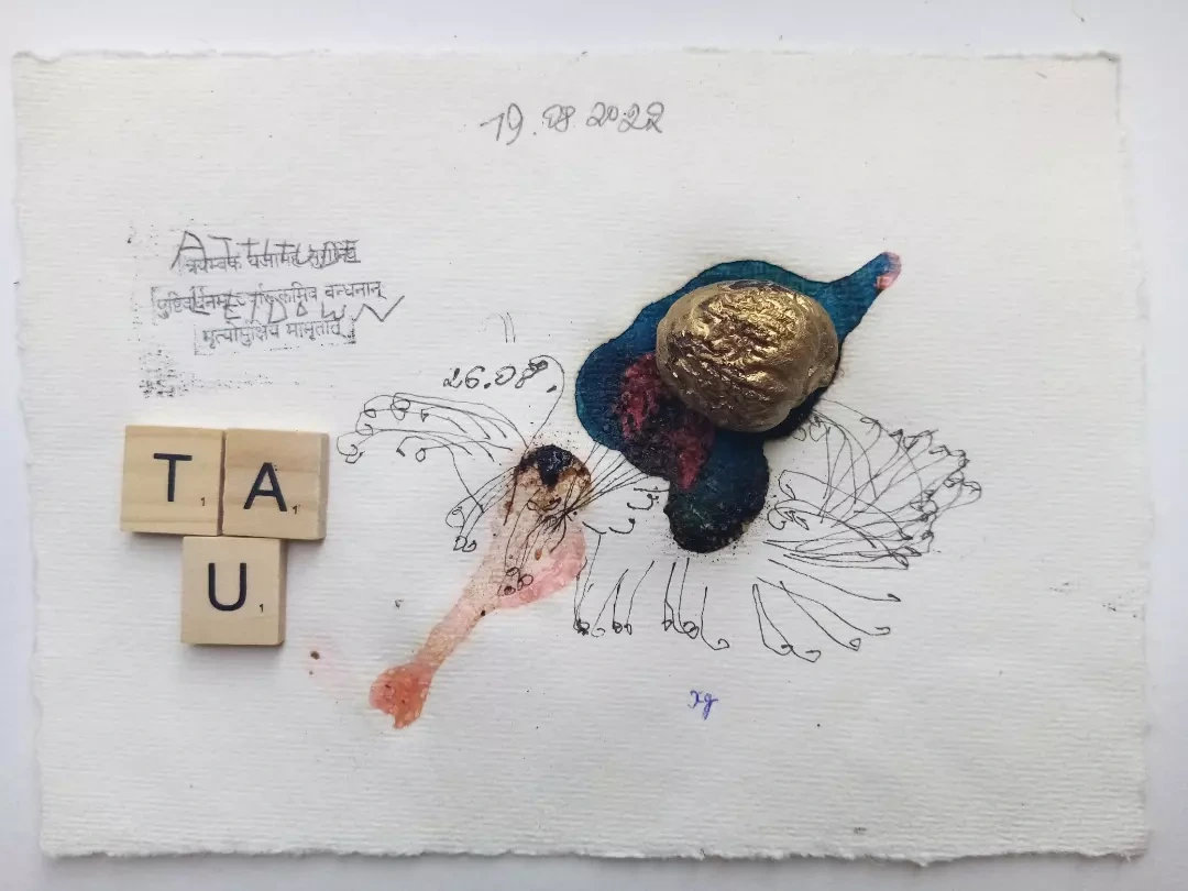 TAU letter tiles with circular forms and inscriptions on paper