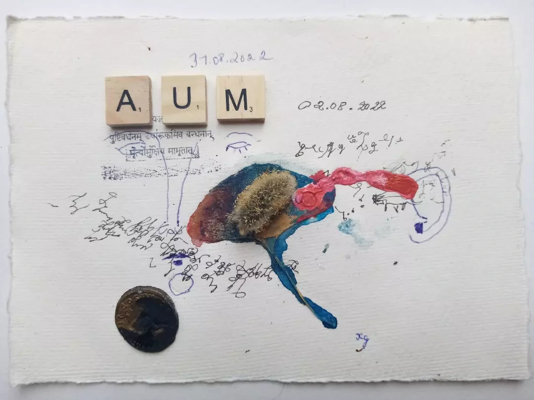 AUM letter tiles, handwriting and coloured material on pale paper